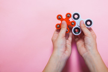 Teenager hands holding popular toy fidget spinner.