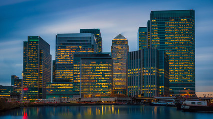 London, England - The skyscrapers of Canary Wharf, the famous financial district of London at blue...