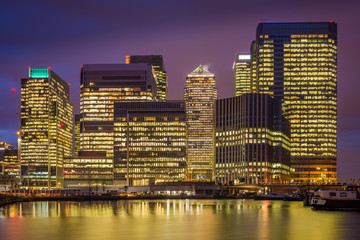 London, England - The skyscrapers of Canary Wharf, the famous financial district of London at blue...