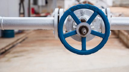 Close up of manual operate ball valve at factory. Pipes and valves industrail equipment.