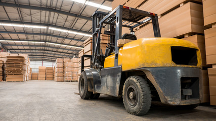 Yellow forklift in a large warehouse. Industry concept.