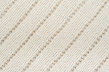 Sweater or scarf fabric texture large knitting. Knitted jersey background with a relief pattern. Wool hand- machine, handmade.