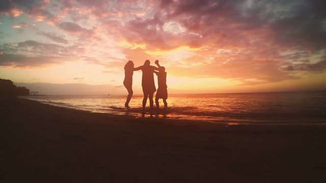 Group of friends celebrating on the beach.