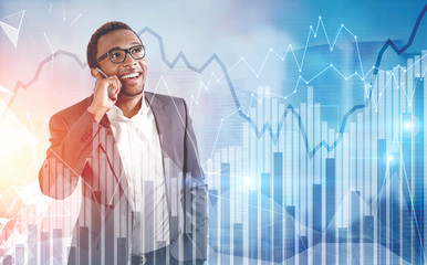 African American man on a phone, graphs, city