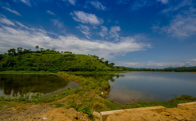 Lake in in the coast of Same, surrounded with abundat vegetation in a sunny day in the Ecuadorian coasts
