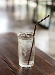 Water glass on wooden table in a restaurant