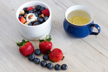 healthy start to the day - lemon juice  fruit yogurt and museli