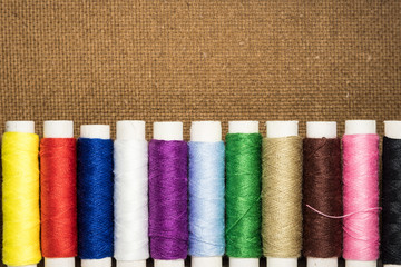 Colored thread coils on white background