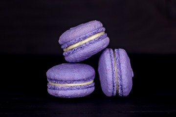 Classic French macaroons on a black background