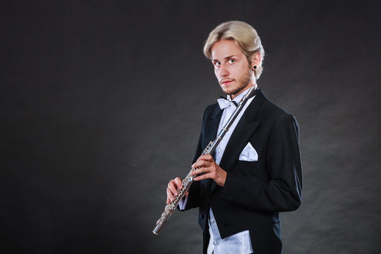 Elegantly dressed musician holding flute