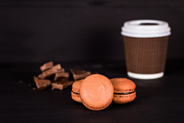 Classic French macaroons on a black background
