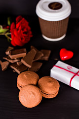 Classic French macaroons on a black background