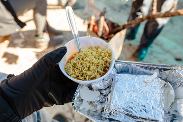 Breakfast for tourist in foiled pack with cooked instant noodle in the bowl in winter in Zero Point at Lachung. North Sikkim, India.