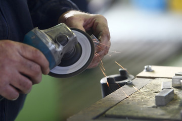 Shaping a metal with a grinder