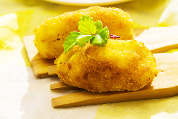 Stuffed croquette on wooden cover