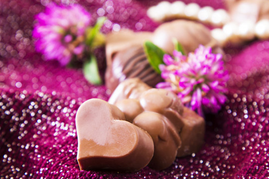 Assortment of chocolates and pearl necklace