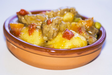 Clay casserole with beef stew isolated on white