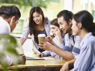 asian and caucasian business people working together in office
