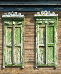 Windows on the façade of the building. carved shutters