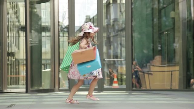 Cute little girl with shopping bags, happy shopping