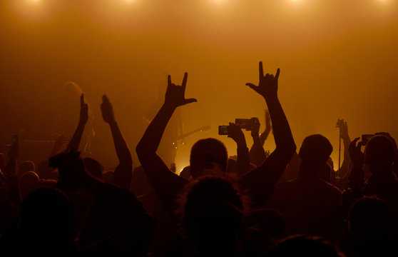 Man raising up hands at rock concert