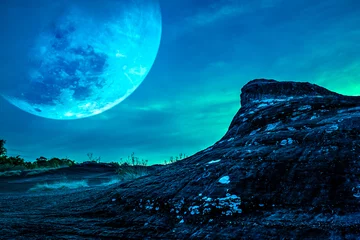 Photo sur Plexiglas Ciel Landscape of the rock against blue sky and big moon above wilderness area in forest.