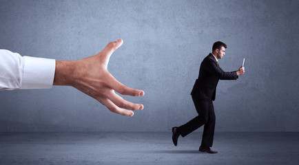 Fototapeta premium Businessman running from hand