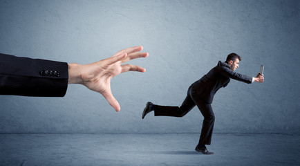 Businessman running from hand