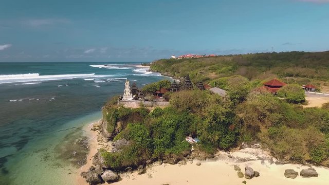 Aerial view of balinese temple on cliff shore in south Bali, moving forward