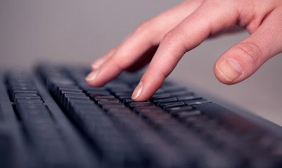 Close up of hand pressing keyboard buttons