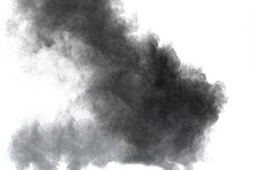 Black powder explosion. Closeup of black dust particles explode isolated on white background.