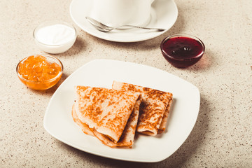 Cup of tea with jam, sour cream and russian pancakes - blini. Toned