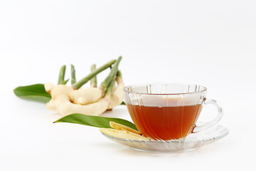 slice of fresh ginger root and tea isolated on white