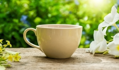 White cup of hot tea on wooden board .Afternoon teatime in the garden. Selective focus.
