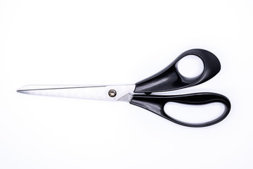 Office supply: A scissor with black handle isolated on white background.