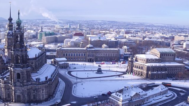 Drone view over historical city center of Dresden, Germany - Aerial of famous church "Hofkirche" and "Semperoper", the castle of the city and the building "Zwinger" in winter sunset
