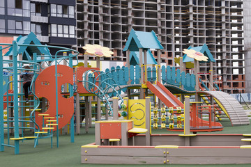 Children's playground in the background of the newly built apartments