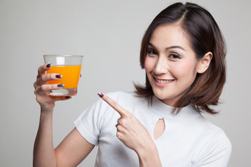 Young Asian woman point to orange juice.