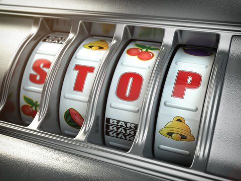 Stop gambling addiction concept. Slot machine with text stop.