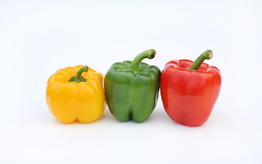 Green, red and yellow bell pepper isolated on white background.