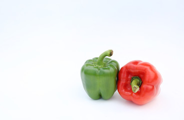 Green and red bell pepper isolated on white background.