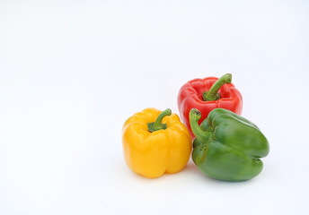 Green, red and yellow bell pepper isolated on white background.