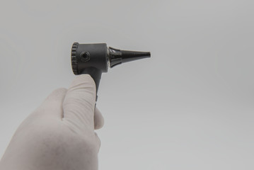 Otoscope  in hand doctor on the white background . medical equipment .