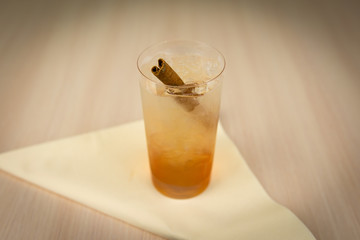 Cocktail with cinnamon on wooden table 