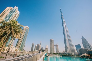 Fototapeta na wymiar Amazing Dubai skyscrapers view and boy on the bridge 