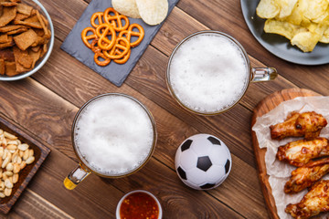 Appetizers and beer on the table for watch the football match.