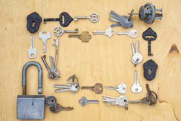 old keys and lock frame on a wooden background, top vie with copy space for your text. security protection concept.