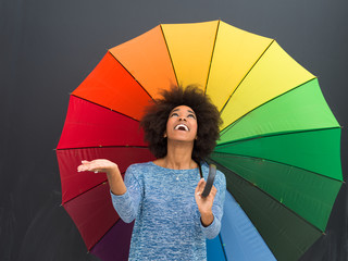 african american woman holding a colorful umbrella