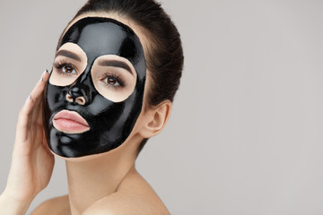 Female Beauty Face Skin Masking. Girl With Black Peeling Mask