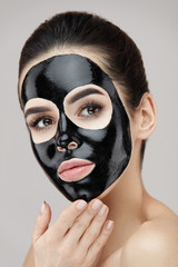 Beauty Skin Care Mask. Portrait Woman With Black Peeling Mask